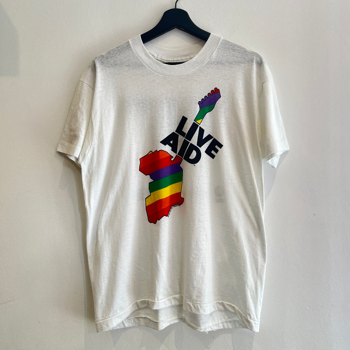 1985s Live Aid Logo T-Shirt with This Shirt Saves Lives Letters Print