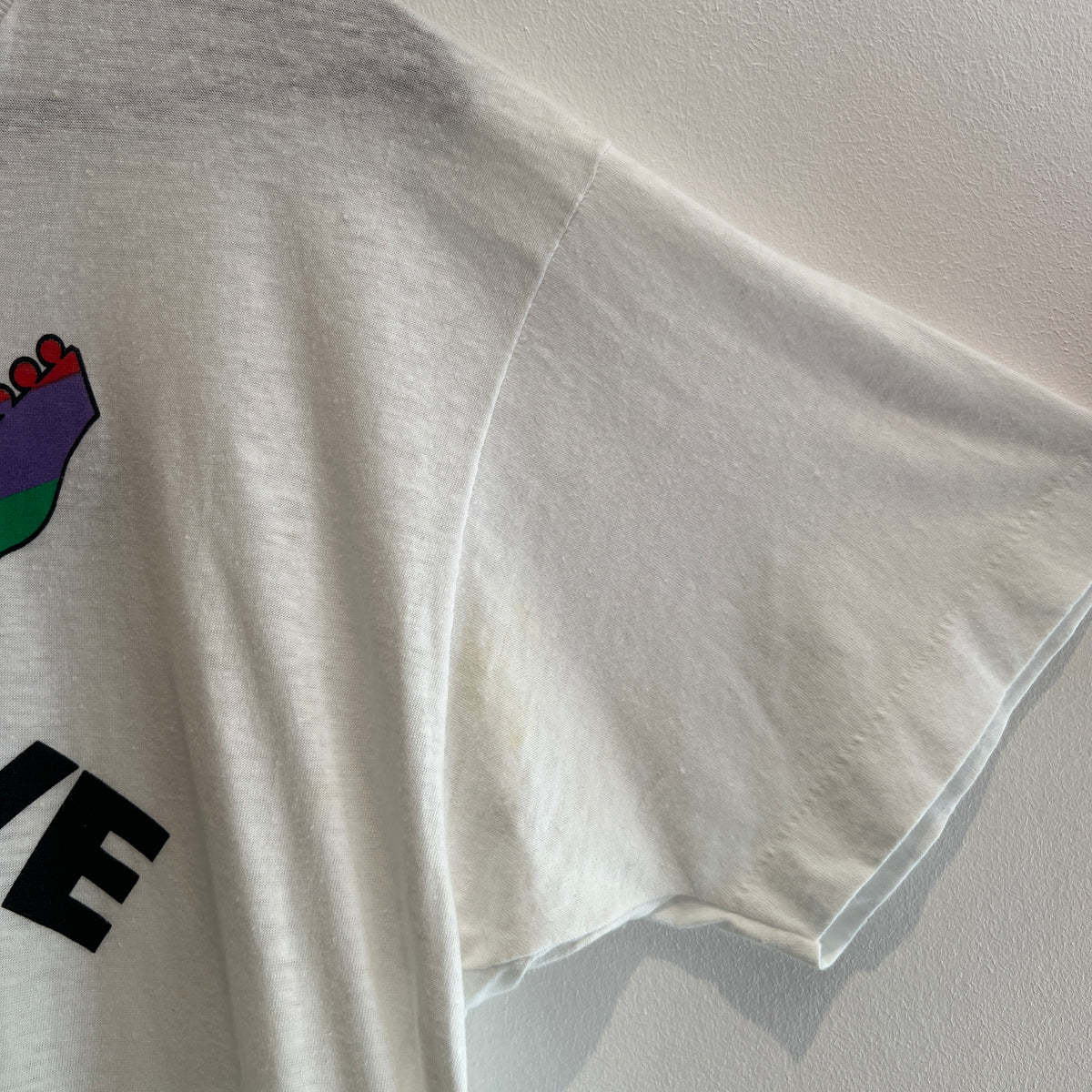 1985s Live Aid Logo T-Shirt with This Shirt Saves Lives Letters Print