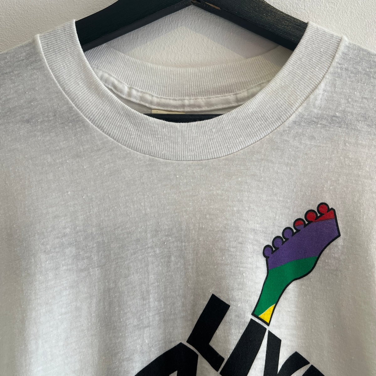 1985s Live Aid Logo T-Shirt with This Shirt Saves Lives Letters Print