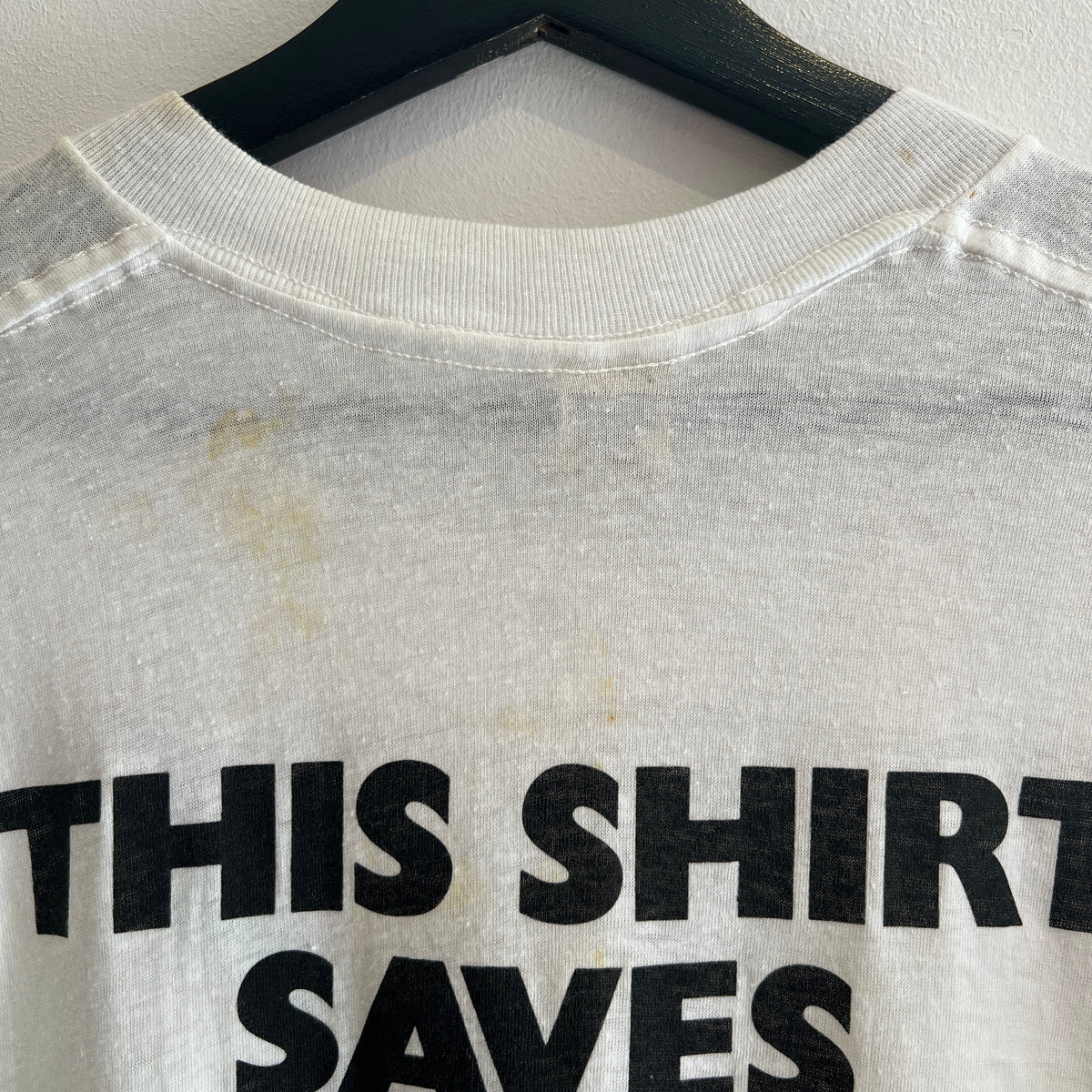 1985s Live Aid Logo T-Shirt with This Shirt Saves Lives Letters Print