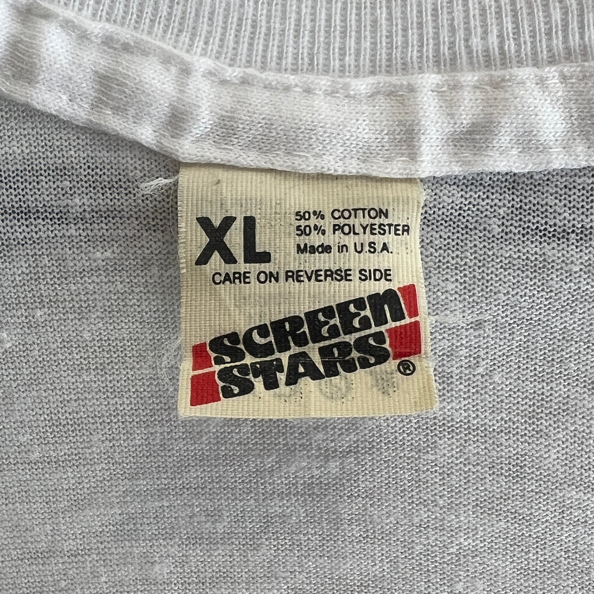 1985s Live Aid Logo T-Shirt with This Shirt Saves Lives Letters Print