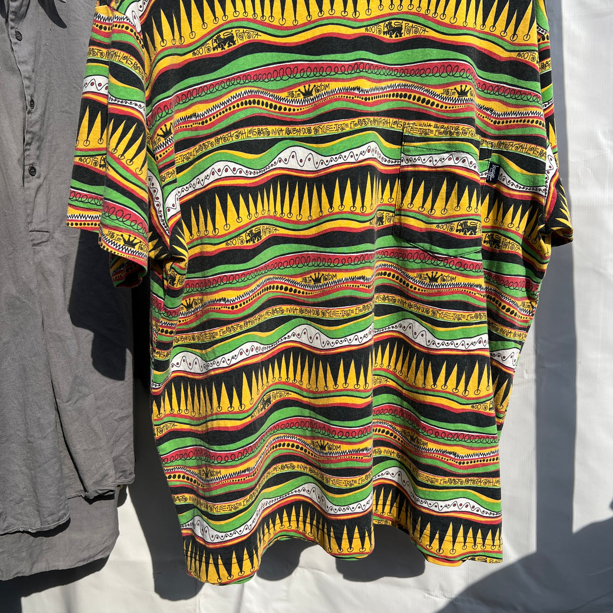 1980s Stüssy "TomTom" Irie Roots and Rasta Rydim Pocket T-Shirt with All-over Print